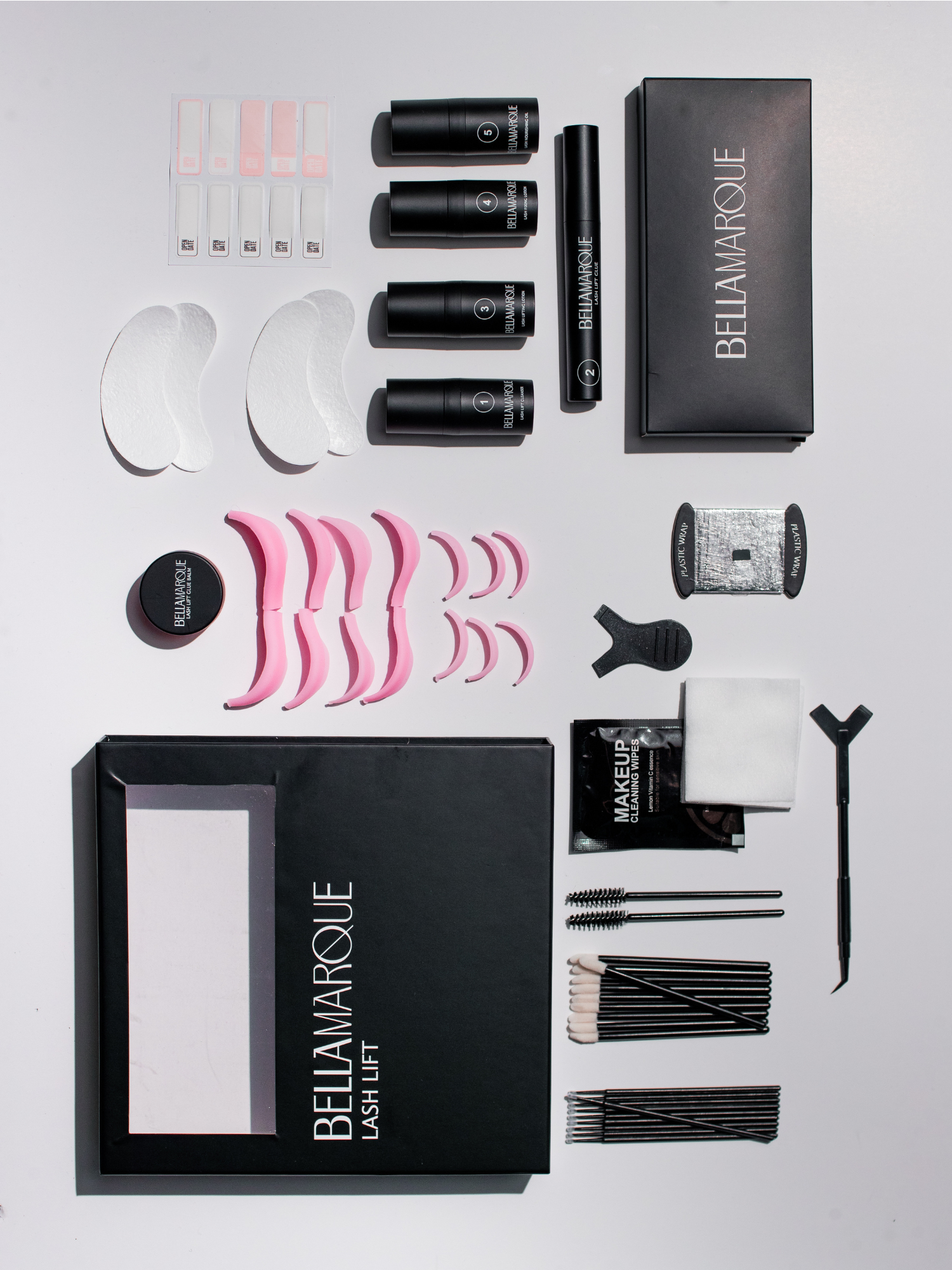 Top view of BELLAMARQUE Lash Lift kit box open with multiple lash treatment components laid out.