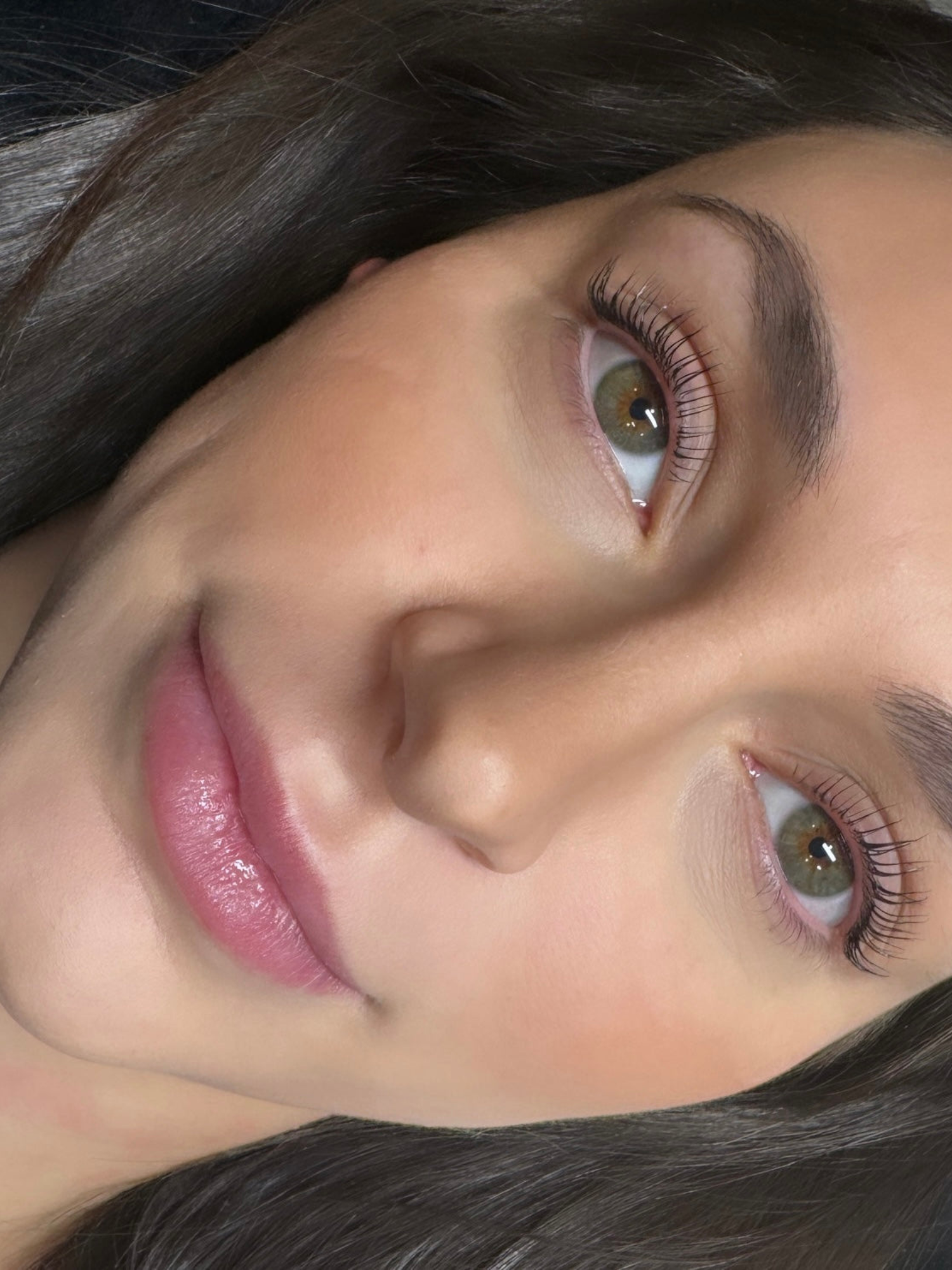 Close-up of a woman’s face showing natural eye look, labeled as before and after using lash lift.