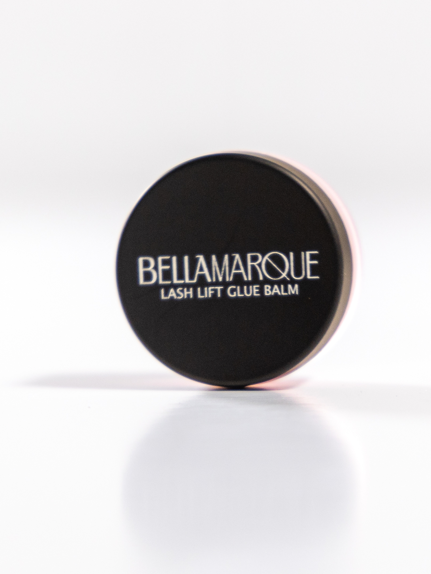 Black lash balm container on white background