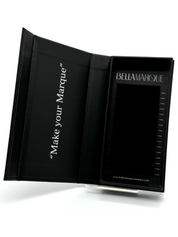 A black lash extension packaging open, showing multiple rows of fine black lashes with lengths labeled, next to the 'BELLAMARQUE' branding and website link.