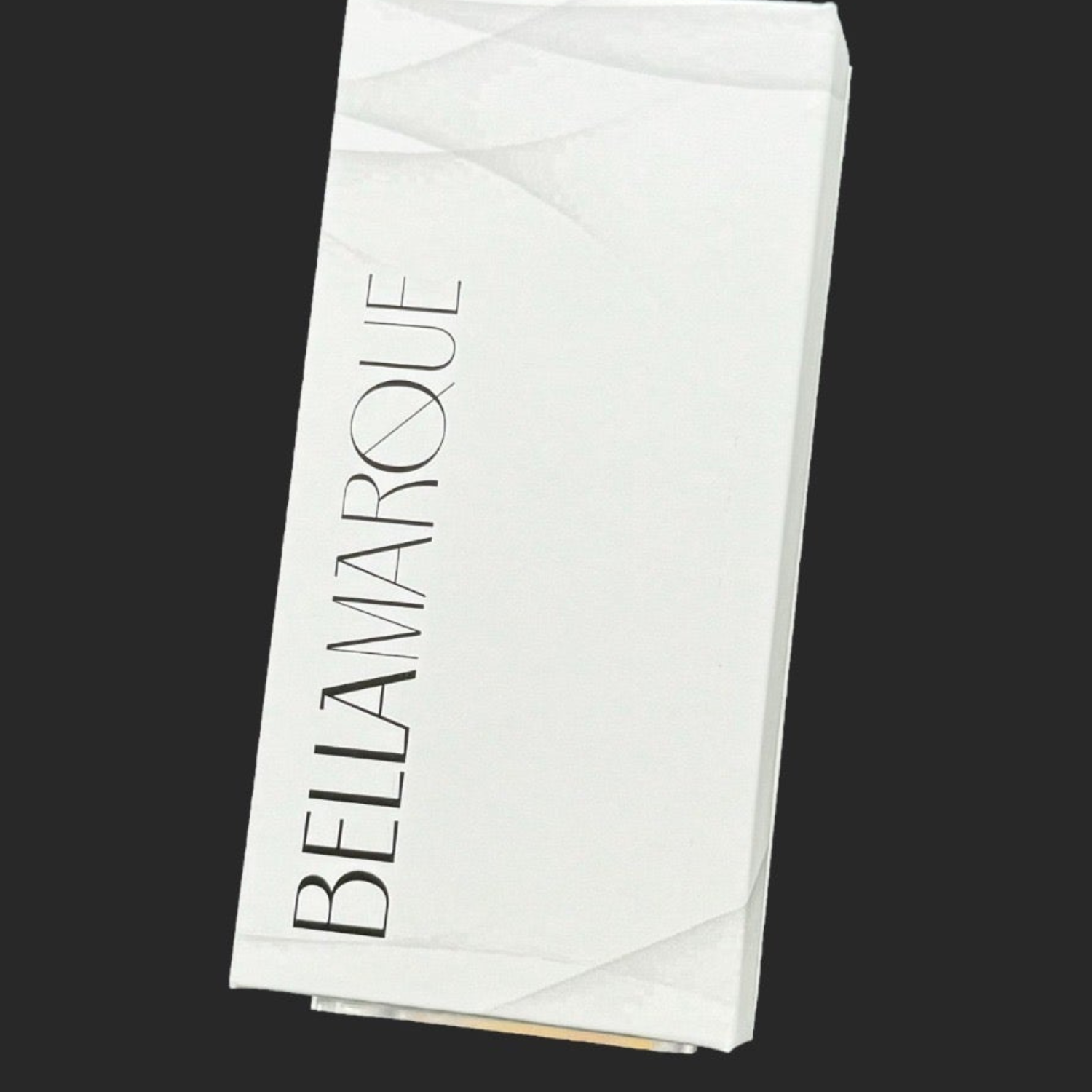 Closed white packaging box with 'BELLAMARQUE' in bold, elegant font on the top, set against a dark background.